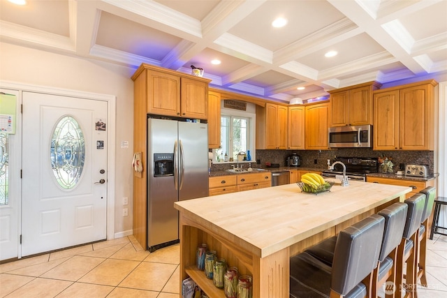 kitchen featuring tasteful backsplash, wood counters, and appliances with stainless steel finishes