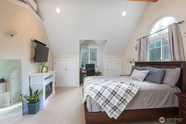 bedroom featuring lofted ceiling and light colored carpet