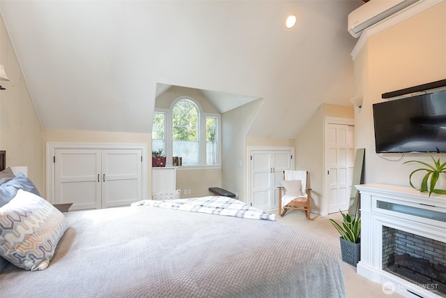 carpeted bedroom with lofted ceiling, an AC wall unit, and a fireplace