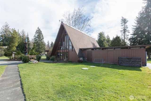 view of side of property with a lawn
