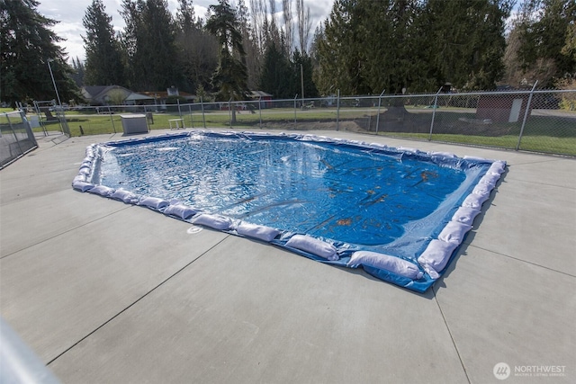 view of pool with a fenced in pool, a patio area, and fence
