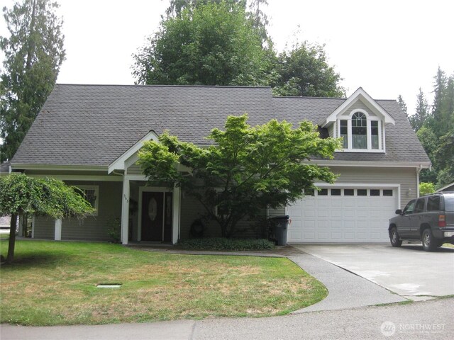 363 Dungeness Mdws, Sequim, WA 98382 - view of front of house featuring concrete driveway, a front yard, an attached garage, and a shingled roof