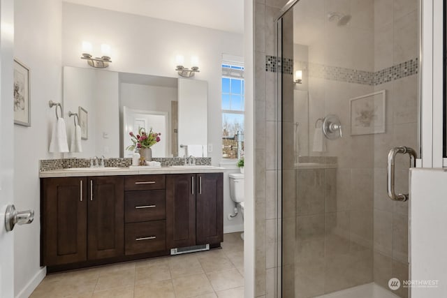 bathroom featuring vanity, walk in shower, tile patterned floors, and toilet