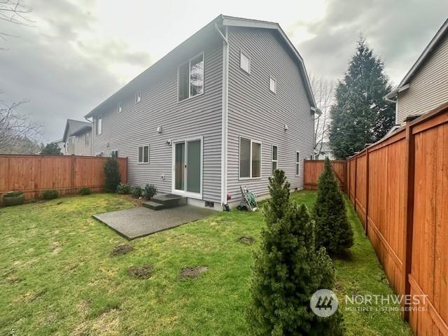 back of house featuring a yard and a patio area