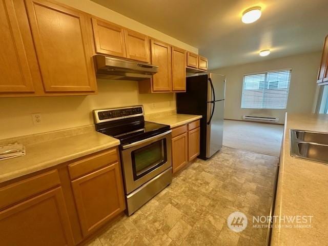 kitchen with a baseboard radiator, appliances with stainless steel finishes, and sink