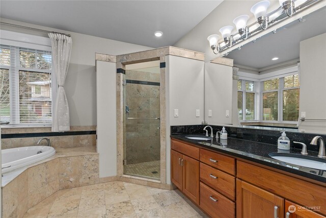 bathroom with vanity, plenty of natural light, a chandelier, and separate shower and tub