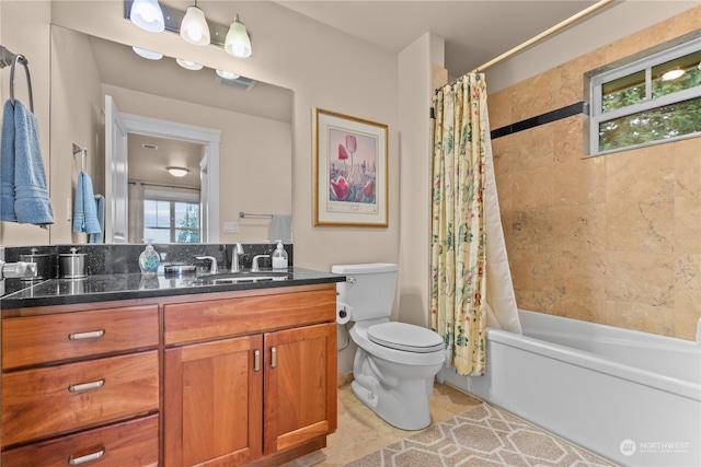 full bathroom with vanity, toilet, and shower / bath combo with shower curtain