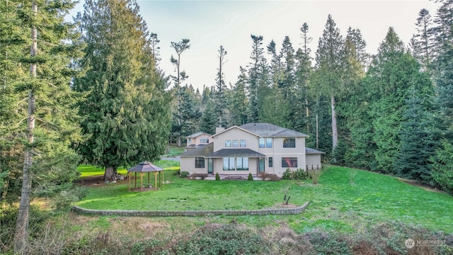 view of front of house with a gazebo and a front lawn