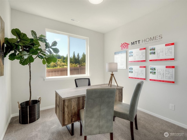 dining room featuring light carpet