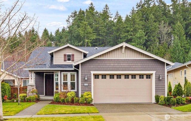 view of front of property featuring a garage, driveway, and roof with shingles