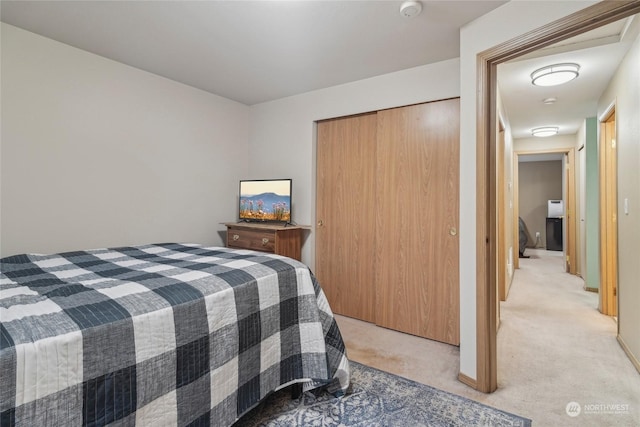 bedroom with light carpet and a closet