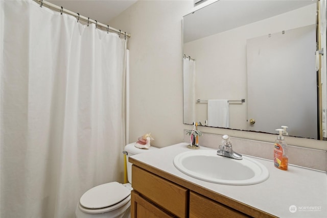 bathroom with vanity and toilet