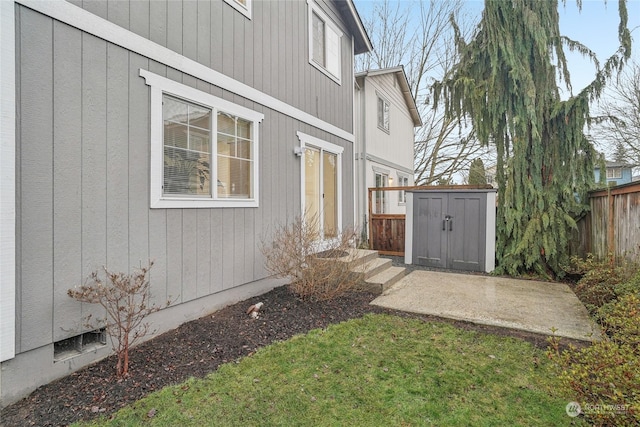 view of yard with a shed and a patio area