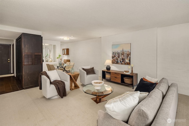 carpeted living room featuring a textured ceiling