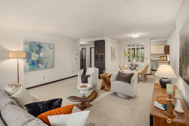 carpeted living room featuring a textured ceiling