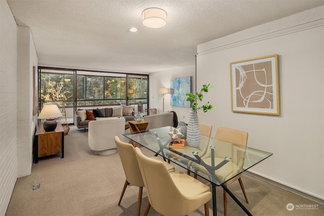 dining space featuring light carpet and a textured ceiling