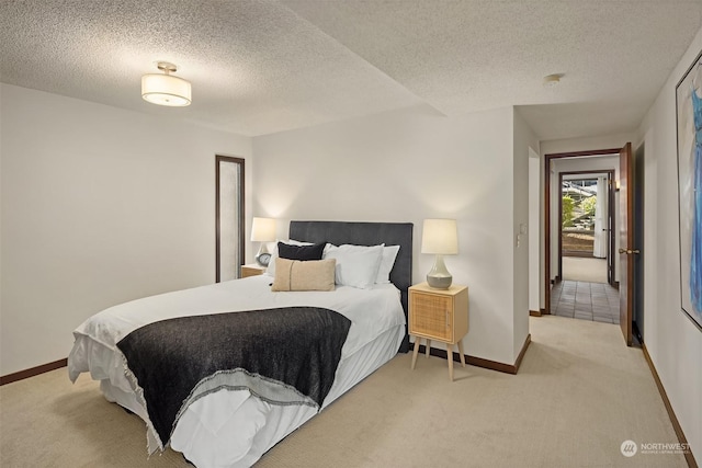 carpeted bedroom featuring a textured ceiling