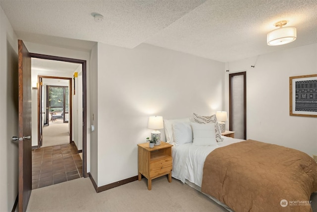 carpeted bedroom featuring a textured ceiling