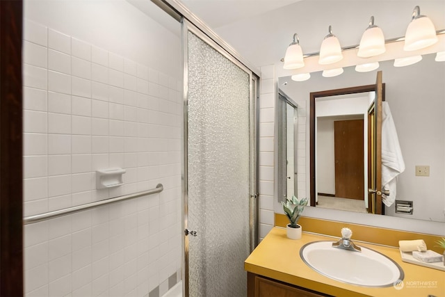 bathroom with vanity and a shower with shower door