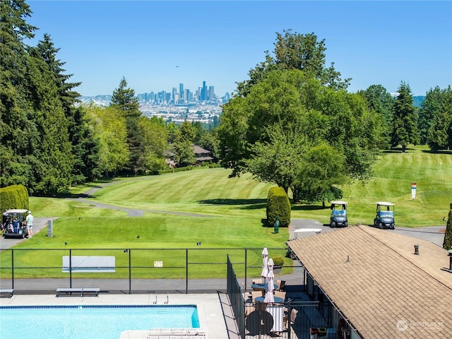 view of pool with a lawn and a patio