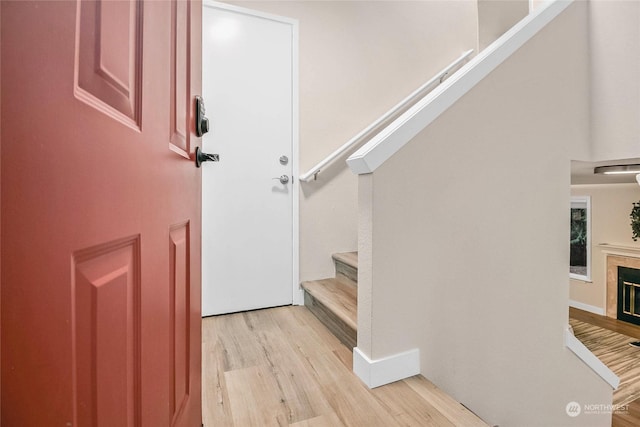 staircase with hardwood / wood-style flooring