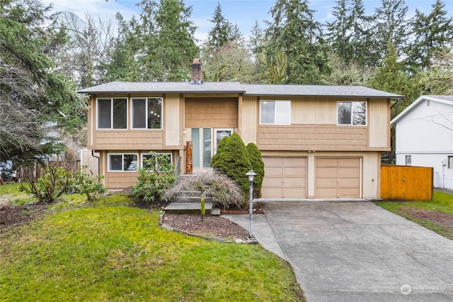 split foyer home with a garage and a front yard