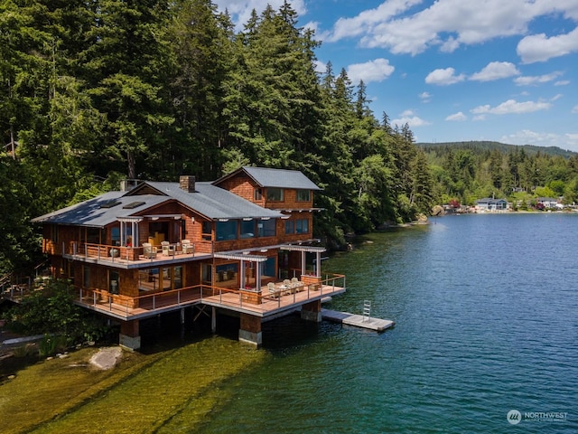 rear view of property with a water view