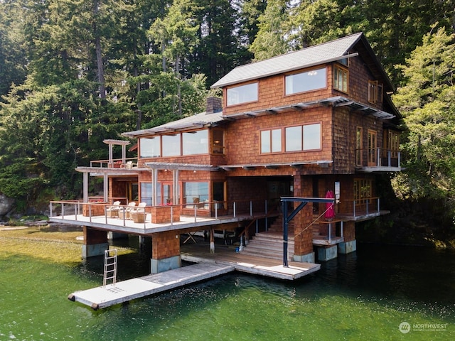 back of house featuring a water view