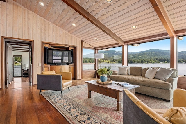 living room with a healthy amount of sunlight, lofted ceiling with beams, wood-type flooring, and wooden ceiling