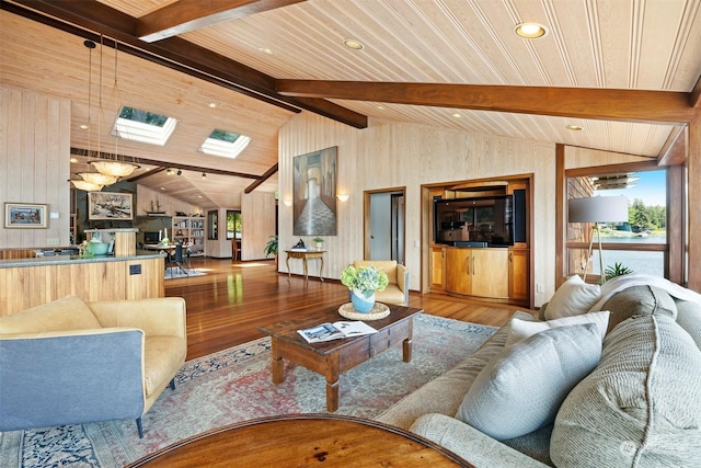 living room featuring wood ceiling, plenty of natural light, vaulted ceiling with skylight, and wood-type flooring