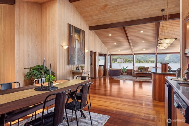 dining area featuring beamed ceiling, wood-type flooring, sink, a water view, and wooden ceiling