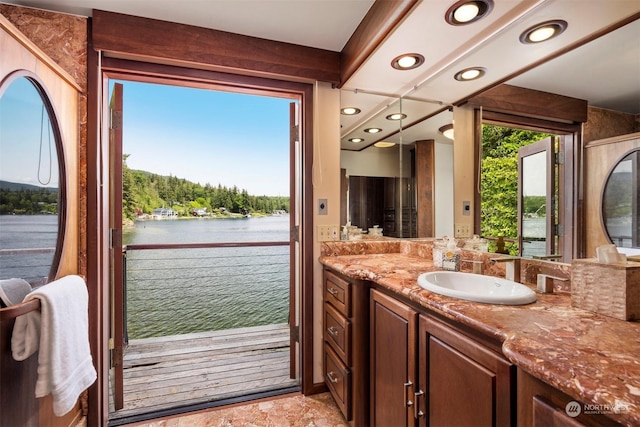 bathroom featuring vanity, a wealth of natural light, and a water view