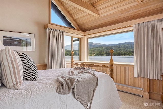 bedroom with lofted ceiling with beams, a water and mountain view, access to exterior, wood ceiling, and baseboard heating