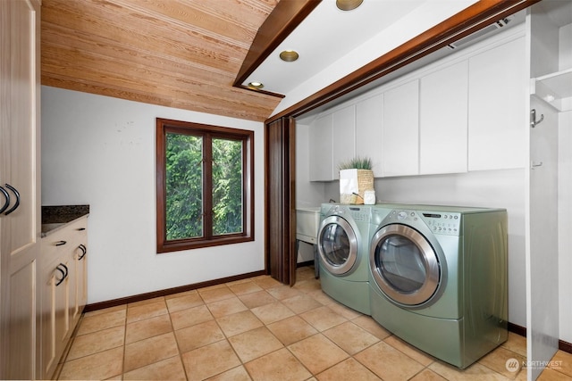 laundry room featuring light tile patterned floors, wood ceiling, washer and clothes dryer, and cabinets