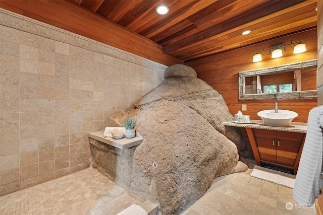 bathroom featuring vanity, wooden ceiling, and wood walls