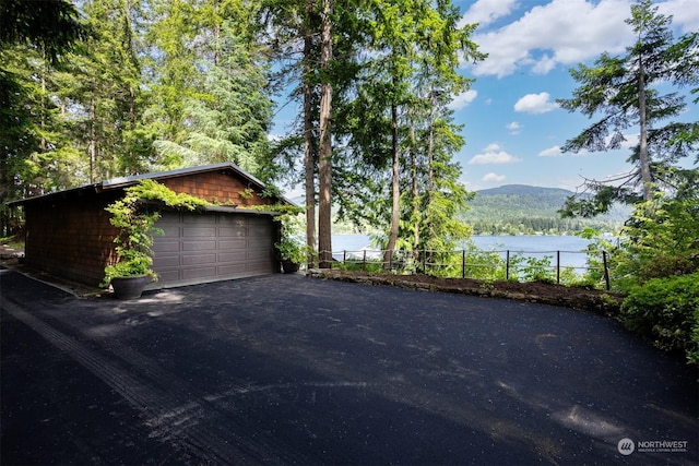 exterior space with a water and mountain view