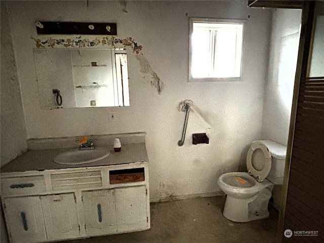 bathroom featuring vanity and toilet