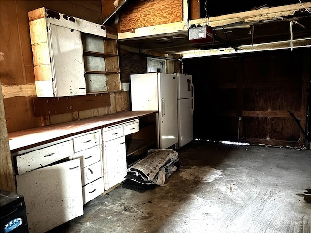 kitchen with white cabinetry and white fridge