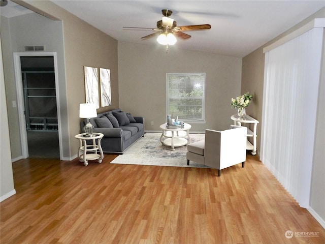 living room with vaulted ceiling, wood-type flooring, and ceiling fan