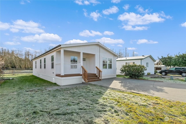 view of front of property with a front yard and covered porch