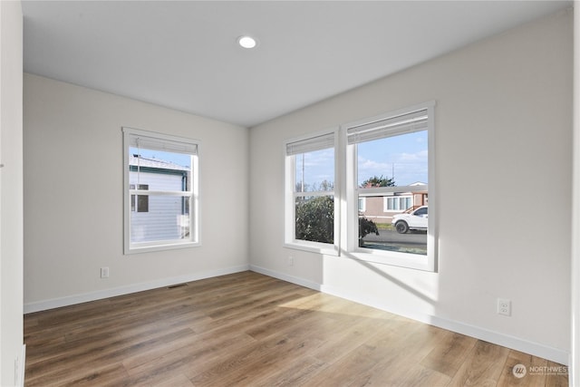 unfurnished room featuring hardwood / wood-style flooring