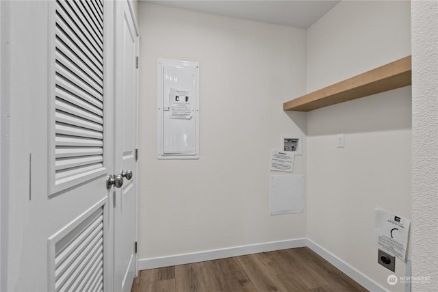 clothes washing area featuring hookup for a washing machine, dark hardwood / wood-style floors, hookup for an electric dryer, and electric panel