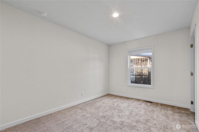 spare room with light colored carpet