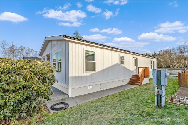 view of side of property with a lawn