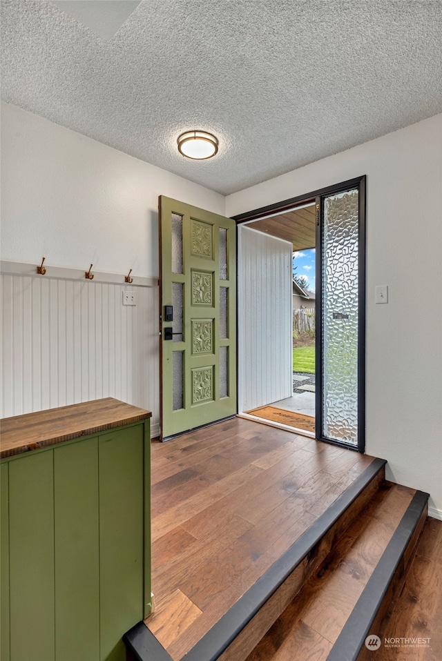 interior space with hardwood / wood-style flooring and a textured ceiling