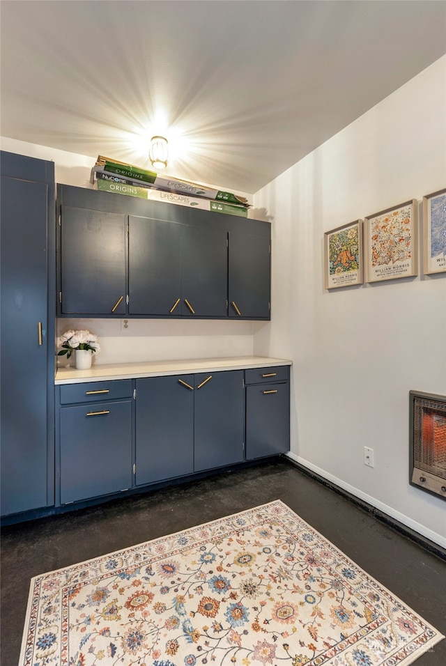 kitchen featuring heating unit and blue cabinets