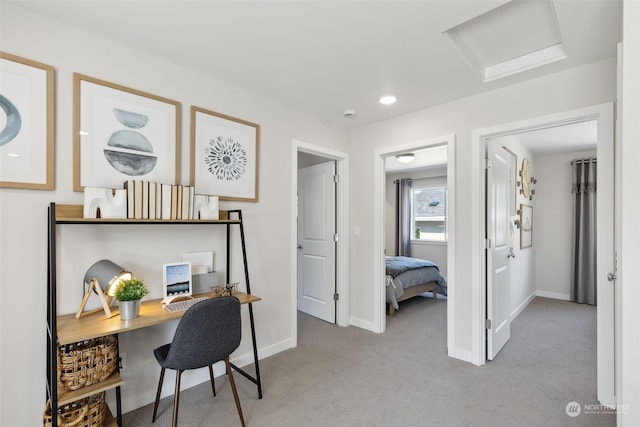 home office with attic access, baseboards, and light colored carpet