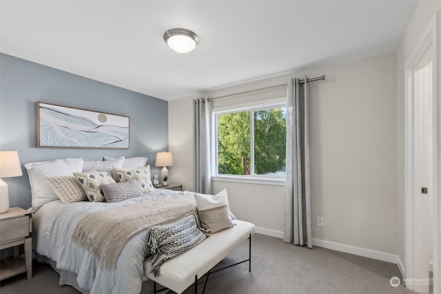 bedroom with carpet flooring and baseboards