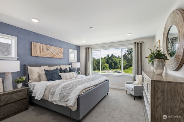 bedroom featuring light carpet and baseboards