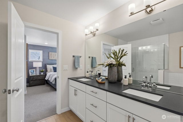 bathroom featuring an enclosed shower, vanity, and hardwood / wood-style flooring